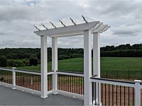 <b>Trex Select Pebble Gray Decking with White Lincoln Vinyl Railing with Black Aluminum Balusters and Island Mist Cocktail Rail with Pergola over Grill Bump Out</b>